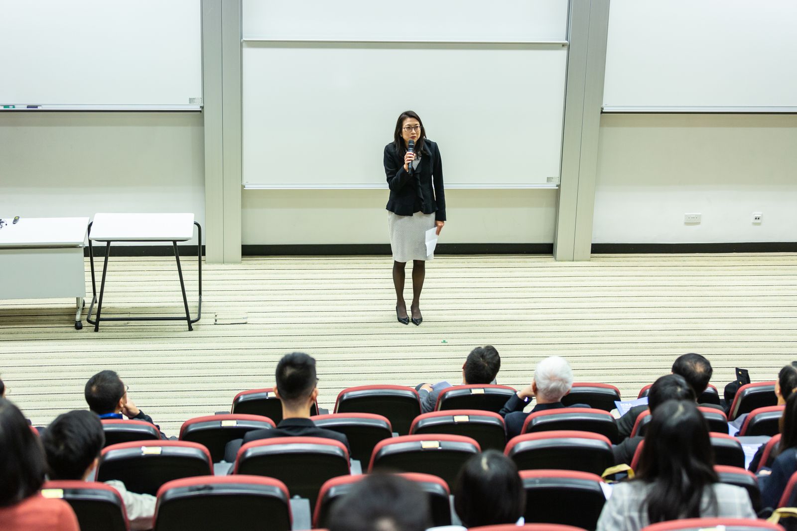 Presenter speaking at a lectern in a seminar room