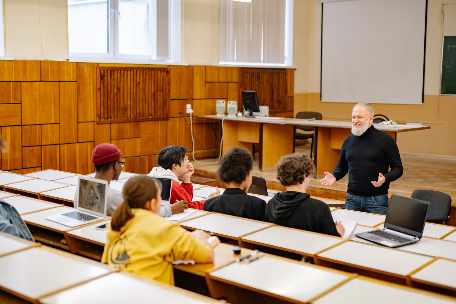 Presenter speaking at a lectern in a seminar room with an audience