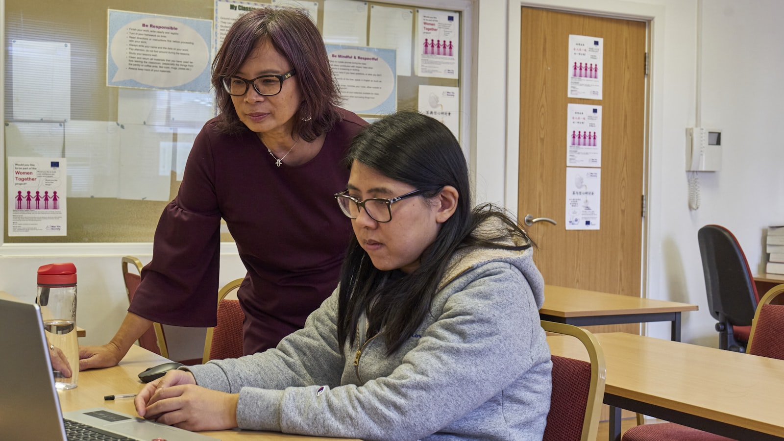 Educator reviewing a document on a laptop