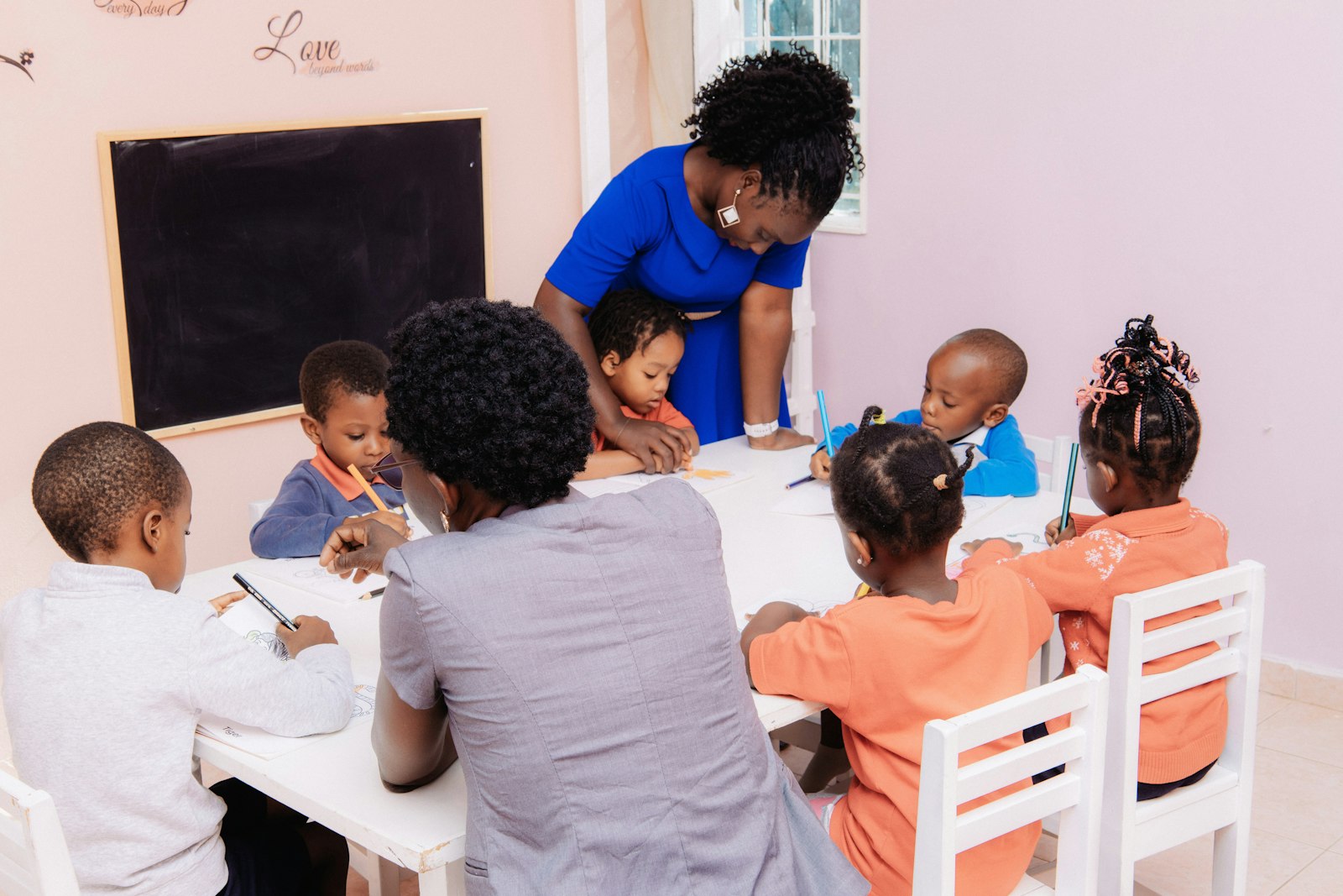 School teacher working with pupils in a classroom
