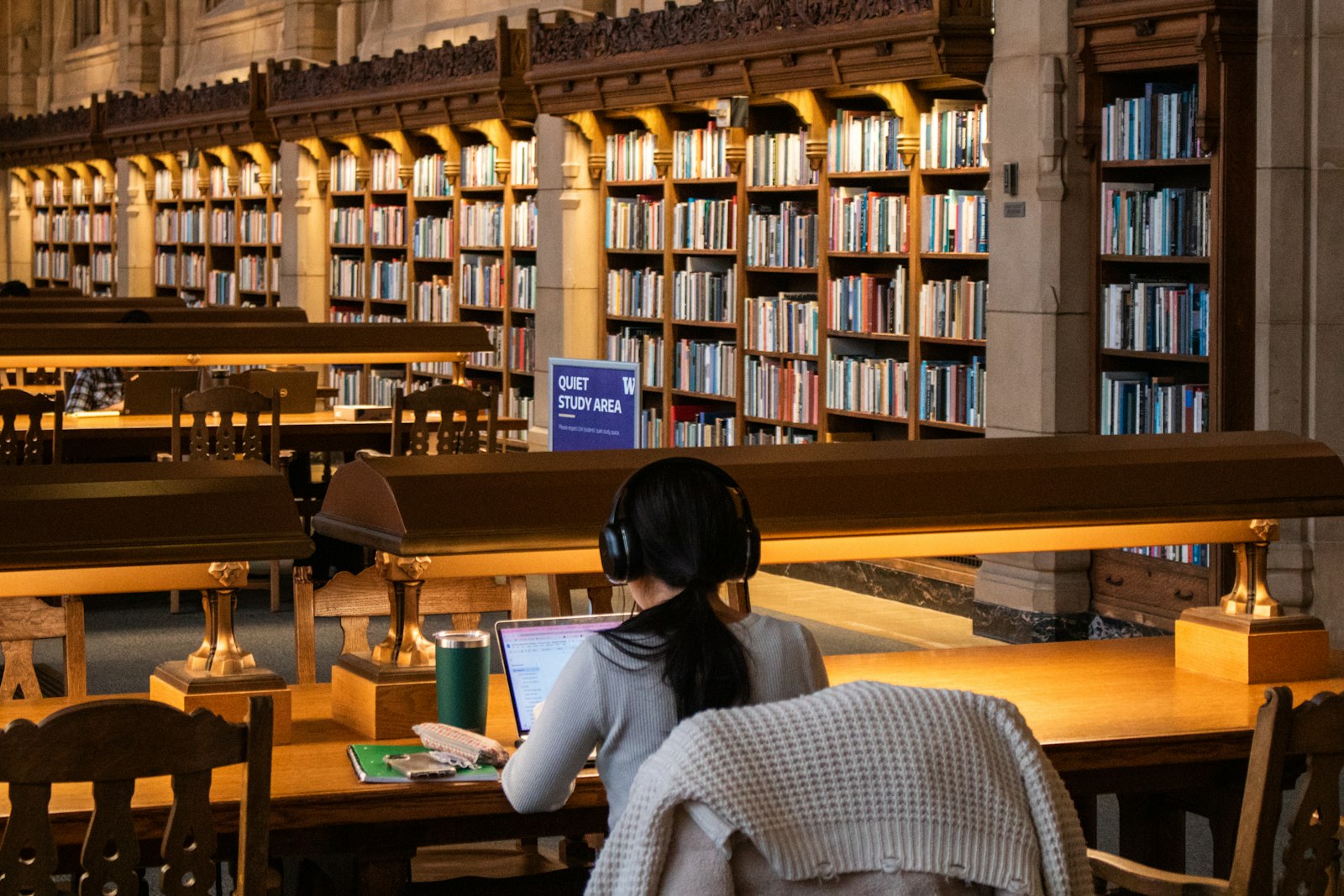 Researcher working with books in a library archive